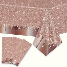 a table cloth with pink glitter on it and two matching napkins next to it