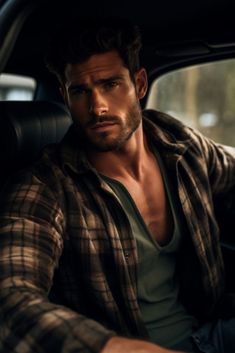 a man sitting in the back seat of a car with his hands on his hips