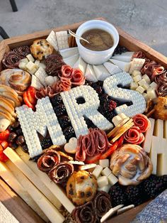 a platter with the word mr and mrs spelled out in letters surrounded by food