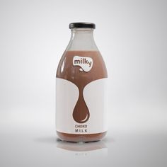 a bottle of milk that is sitting on a table with a white surface and gray background