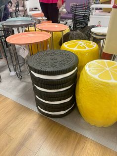 an assortment of colorful stools and tables in a store