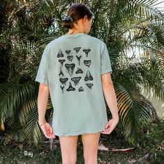 This Respect the Locals Shark Tooth Shirt is printed on a Comfort Colors tee. These tee's are made with 100% ring-spun cotton, giving them a soft and relaxed fit. Perfect for a beach day hunting sharks teeth! Details - made with 100% ring-spun cotton - soft-washed, garment-dyed fabric for soft color and texture - double-needle stitching throughout tee for durability SHIPPING Production time can take 2-7 business days, although the average time is 2.9 days Shipping times in the US is 2-5 business days. *shipping to Alaska, Hawaii, Puerto Rico and unincorporated territories of the US can take an additional 7-12 business days. RETURNS Each shirt is Print-on-Demand, meaning it is not created until you order. Therefore, returns and exchanges are not accepted unless a product arrives damaged. If Shark Tshirt Design, Respect The Locals Shark, Tooth Shirt, Beachy Clothes, Respect The Locals, Shark Conservation, Sharks Teeth, Vsco Aesthetic, Beachy Style