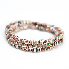 multicolored glass beaded bracelets with silver accents on white background, close up