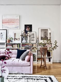 a living room filled with lots of furniture and pictures on the wall above it's coffee table