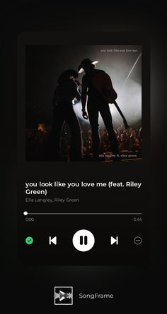 an iphone screen with the music player on it's side and two people standing next to each other