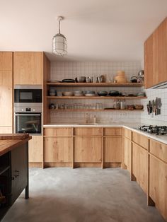 a kitchen with wooden cabinets and stainless steel appliances