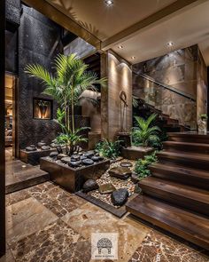 a very nice looking house with some plants in the entry way and stairs leading up to it