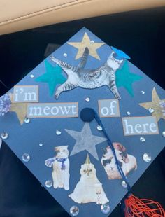 a graduation cap decorated with cats and stars