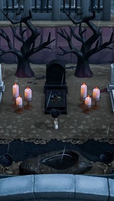 a cemetery with candles and tombstones on the ground