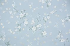 a blue wallpaper with white flowers on it