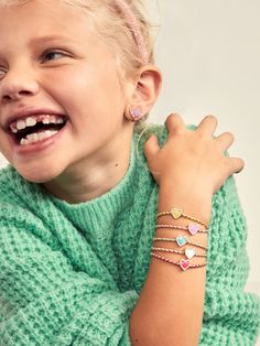 The Sweetheart Kids' Pisa Bracelet Set comes with five unique gold beaded bracelets. Each bracelet is complete with a heart bead in the center in a range of bright colors. Gift as a set to your little one, or split them apart to gift to them and all of their friends. READY TO GIFT: This item comes pre-packaged in a beautiful box.Please note: intended for children 3+ Kids Jewelry Gold, Bracelet Photoshoot, Bracelets Photography, Kid Bracelets, Valentine's Day Gifts For Kids, Kid Jewelry, Personalized Placemats, Jewelry Mood Board, Bracelets For Kids