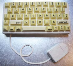 a keyboard and mouse on a table with the words happy birthday louis written on it