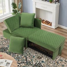 a green couch sitting on top of a rug in a living room