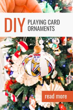 a hand holding a christmas ornament with the words diy playing card ornaments