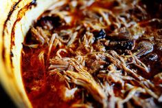 a close up of food on a plate with meat and sauce in the middle,