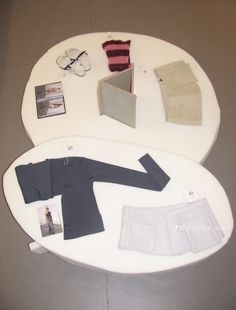 an assortment of clothing and accessories displayed on a white table top with grey flooring