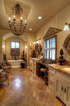 a large bathroom with chandelier, sink and tub in the middle of it