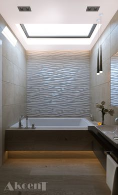 a bathroom with a skylight above the bathtub and two sinks in front of it