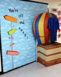 a colorful hot air balloon sitting in front of a bulletin board