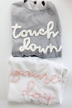 two t - shirts with the words game day written in white and pink on them