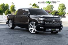 a black truck parked in a parking lot