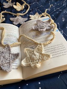 an open book with crocheted ornaments on it