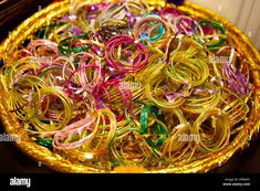 many colorful bracelets are in a basket