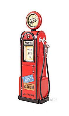 an old fashioned red gas pump with a clock on it's top and side