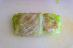 a cabbage leaf on a cutting board ready to be cut into small wedges or pieces