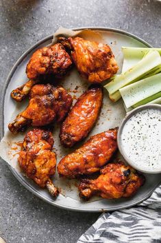 chicken wings and celery on a plate with ranch dressing