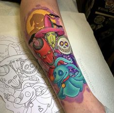 a colorful tattoo on the leg of a person with an elephant and clowns in it