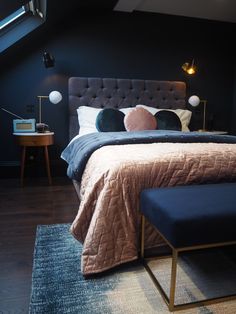 a large bed sitting under a skylight in a bedroom