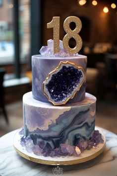 a purple and gold marble cake with the number eighteen on it's top tier