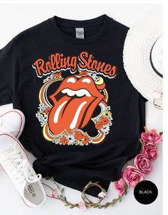 Step back in time and rock out in style with our Vintage Flower Rolling Stone Tee! 🌸🎸 This retro-inspired t-shirt features a classic Rolling Stone logo beautifully intertwined with vibrant flowers, capturing the free-spirited essence of rock 'n' roll and the timeless charm of the 70s. 🌼✨ Crafted from super-soft, high-quality fabric, this tee offers ultimate comfort and a perfect fit, making it an essential addition to your wardrobe. Whether you're heading to a concert, a festival, or just channeling your inner rock star, this tee will have you looking effortlessly cool and totally groovy. 🌟👕 Get ready to roll and bloom with style! 🌿🎶🛒 Rolling Stone Logo, Stone Logo, Rolling Stones Tee, Rolling Stones Logo, Tennessee Orange, Vibrant Flowers, Rolling Stone, Vibrant Flower, Step Back