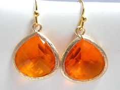 Stunning glass gold earrings in orange color! These beautiful glass faceted framed stones are suspended from gold plated ear wires. Absolutely gorgeous! Glass bead: 16mm*16mm Earrings measure 33mm including the ear wire MORE COLORS AVAILABLE IN MY SHOP! UPGRADE TO GOLD FILLED EAR WIRE FOR AN ADDITIONAL FEE. ALSO AVAILABLE IN SILVER AS SEEN IN THE LAST PICTURE: https://www.etsy.com/listing/103160164/orange-earrings-silver-earrings-silver?ga_search_query=orange Visit my shop at http://www.etsy.com Orange Teardrop Earrings As Gift, Nickel Free Orange Jewelry For Party, Nickel-free Orange Jewelry For Party, Nickel Free Orange Earrings For Party, Orange Teardrop Earrings For Party, Nickel-free Orange Earrings For Party, Orange Earrings, Jewelry Bridesmaid, Earrings Bridesmaid