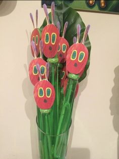 a vase filled with paper flowers on top of a table