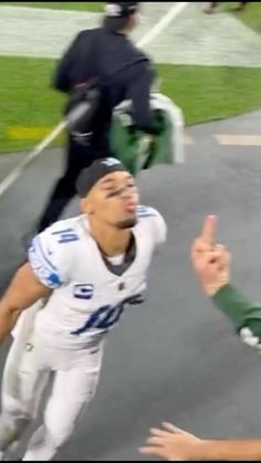 two football players giving the finger sign to each other