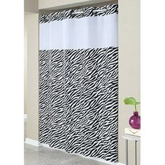 the shower curtain is decorated with black and white zebra print on it's side