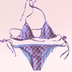 The Katie is a classic triangle bikini in pink and white gingham. The top and the bottoms have ties sides with seamless stitching. Gingham Triangle Top Swimwear For Beach Season, Plaid Triangle Top Swimwear For Summer, Early 2000s Aesthetic Grunge, Plaid Triangle Top Swimwear For Beachwear, Gingham Triangle Top Swimwear For Pool, Summer Triangle Top Plaid Swimwear, Summer Plaid Triangle Top Swimwear, Spring Gingham Swimwear With Triangle Top, 2000s Aesthetic Grunge