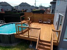 an above ground pool with deck and hot tub