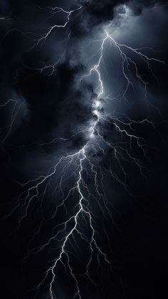 a black and white photo of lightning striking through the night sky with dark clouds in the background