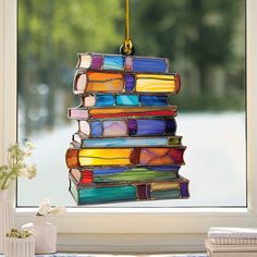 a multicolored stained glass ornament hanging from a window