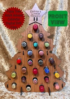 a wooden christmas tree with buttons on it