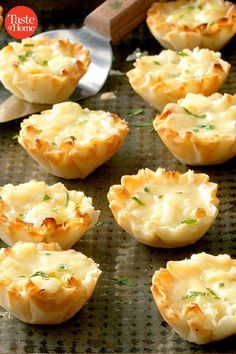 small appetizers with cheese and herbs on a baking sheet