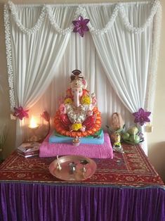 there is a gandap on the table with candles and decorations in front of it