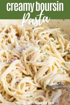 creamy bourssin pasta with parmesan cheese and herbs in a white bowl