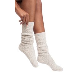 Experience unrivaled comfort as you sink your feet into their opulent softness. Enhanced with non-slip grippers, these socks offer improved mobility without compromising safety. Our Marshmallow Slouch Socks provide a sensory treat that will leave you craving more. Relax and let the tension melt away as these socks envelop you in sumptuous softness. Treat your feet to lavish comfort; they deserve it. Slouch Socks Features Plush and extra comfy Non-slip grippers on the bottom One-size-fits-most, these slouch socks are the perfect match for every sole. Available in multiple colors, heathered or solid Perfect Gift Idea Slouch Socks Material & Care Easy-care Marshmallow fabric, a durable blend of 51% polyester and 49% nylon Machine Wash Cold, Tumble Dry, Low. Slouchy Socks, Cable Knit Socks, Slouch Socks, Bed Socks, Soft Sock, Pop Up Shops, Softies, Heather Black, Knit Socks