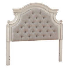 an upholstered headboard with buttons on the top and bottom part of it