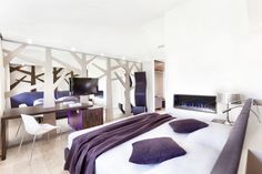 a bedroom with white walls and purple accents