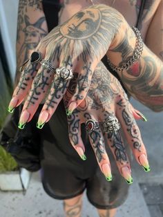 a woman with tattoos and rings on her hands